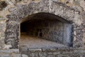 An embrasure for shooting in the thick wall of an old fortress or castle Royalty Free Stock Photo