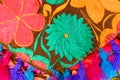 Embroidered flower design with colorful threads on a traditional Mexican style garment