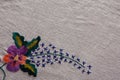 Embroidered flower on old canvas background