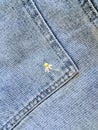 Embroidered flowers on fragment of blue denim jeans texture Royalty Free Stock Photo