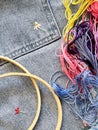Embroidered flowers on fragment of blue denim jeans texture Royalty Free Stock Photo