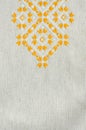 Embroidered fragment on flax by yellow and white cotton threads. Macro embroidery texture flat stitch. Royalty Free Stock Photo