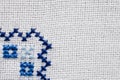 Embroidered fragment on white flax. Royalty Free Stock Photo