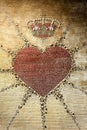 Embroidered heart and heraldic crown on tapestry Royalty Free Stock Photo