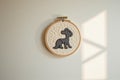 Embroidered hoop art with black dog on textured background with light shadows Royalty Free Stock Photo