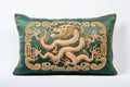 Embroidered pillow with an emerald green dragon image isolated on a white background. Symbol of the year 2024