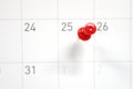 Embroidered red pins on a calendar on the 25th