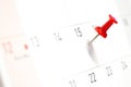 Embroidered red pins on a calendar on the 15th Royalty Free Stock Photo