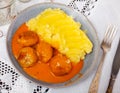 white round plate with meatballs sprinkled with chopped dill in tomato sauce with mashed potatoes Royalty Free Stock Photo