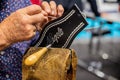 Embroiderer doing needlework on a traditional leather belt Royalty Free Stock Photo