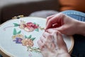 embroiderers hands correcting mistake on a hoop project