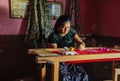 Embroidering a huipil at home