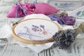 Embroidery bouquet of lavender and tools of needlework