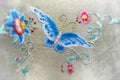 Embroidery a butterfly and flowers. Handmade. Blurred background around the edges. Royalty Free Stock Photo