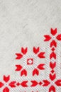 Embroidery design by red and white cotton threads on flax. Christmas background with embroidery. Royalty Free Stock Photo