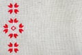 Embroidery design by red and white cotton threads on flax. Christmas background with embroidery. Royalty Free Stock Photo