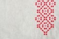 Embroidery design by red and white cotton threads on flax. Christmas background with embroidery. Royalty Free Stock Photo