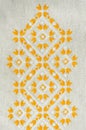 Embroidery design by yellow and white cotton threads on flax. Background with embroidery. Royalty Free Stock Photo