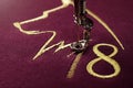 Embroidery with embroidery machine of dog silhouette and number 2018 in gold on claret fabric - chinese new year concept Royalty Free Stock Photo