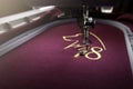 Embroidery with embroidery machine of dog silhouette and number 2018 in gold on claret fabric Royalty Free Stock Photo