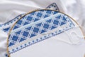 Embroidery hoop with fragment embroidered fabric. Royalty Free Stock Photo