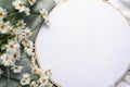 Embroidery hoop mockup with copy space. Background with daisies on fabric, close-up top view. Generative AI
