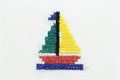 Embroidery of the image of a boat with a sail.