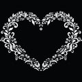 Embroidery inspired heart shape in white with floral elements on black background