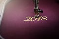 Embroidery with embroidery machine of number 2018 in gold on claret fabric - chinese new year concept Royalty Free Stock Photo