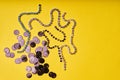 Embroidery products and tools. Black sequins and rhinestones on yellow background