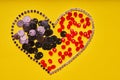 Embroidery products and tools. Heart, rhinestone, sequin and red roundels on a yellow background