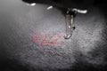 embroidery of red lettering SALE on soft grey fabric with embroidery machine - part view on font and machine head
