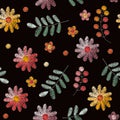 Embroidery seamless pattern with beautiful flowers, leaves and berries on black background. Fashion design. Royalty Free Stock Photo