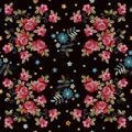 Embroidery seamless pattern with beautiful red roses and blue flowers on black background. Vector floral ornament. Royalty Free Stock Photo