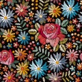 Embroidery seamless pattern with colorful flowers, leaves and berries on black background. Fashion design