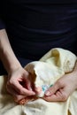 Embroidery in woman hands, female doing flower pattern embroidery on grandma natural clothes