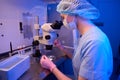 Embryologist is performing in vitro fertilization procedure under microscope