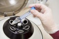 Embryologist putting sample into centrifuge