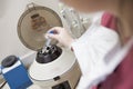 Embryologist putting sample into centrifuge Royalty Free Stock Photo