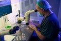 Embryologist researching female cells and preparing them for biopsy