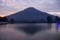 A fish pond containing koi with a background of Sindoro mountain Royalty Free Stock Photo