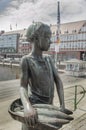 The fish girl Jantje Vis stands on the Delft stairs with a flat basket