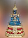 Emerald Buddha body on a blue background blur. Royalty Free Stock Photo