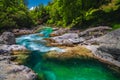 Emerald color Soca river with rocky shoreline, Bovec, Slovenia Royalty Free Stock Photo