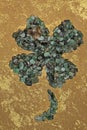 Emerald crystals four leaf clover shape on gold luxury painted background