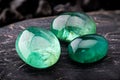 The emerald gemstone jewelry photo with black stones and dark lighting Royalty Free Stock Photo