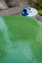 An emerald green Chinese glazed table and blue and white porcelain stools Royalty Free Stock Photo