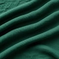 Emerald green fabric with a textured, woven surface. The material is arranged in Royalty Free Stock Photo
