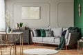 Emerald green and grey living room interior design with abstract painting on the wall Royalty Free Stock Photo