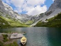 Emerald-green Partnunsee with colorful boats in Praettigau, Grisons, Switzerland. Royalty Free Stock Photo